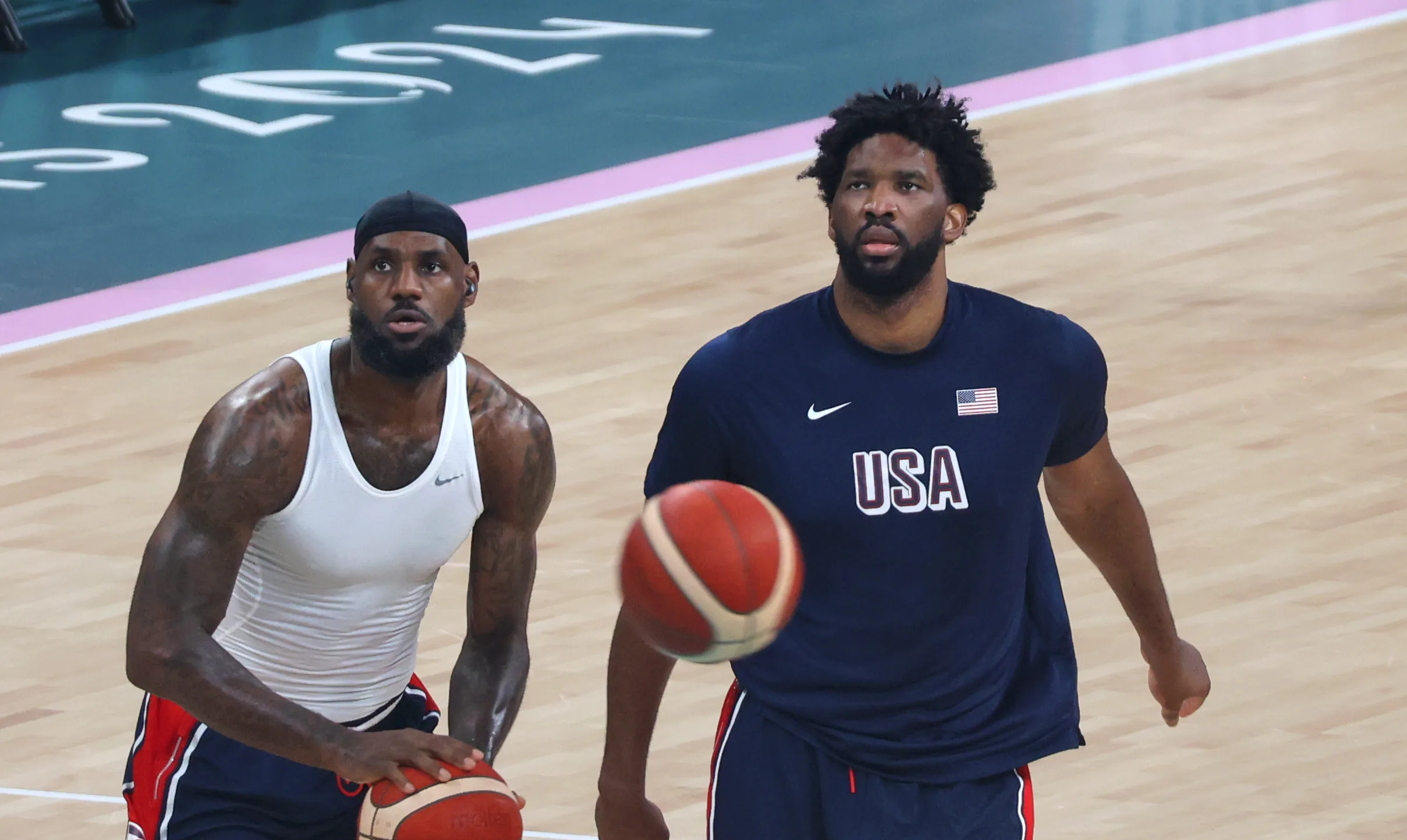Open the featured image for LeBron James Enters Year 24 With a New Philadelphia Test LeBron James and Joel Embiid warm up with basketballs at the Paris 2024 Olympics.