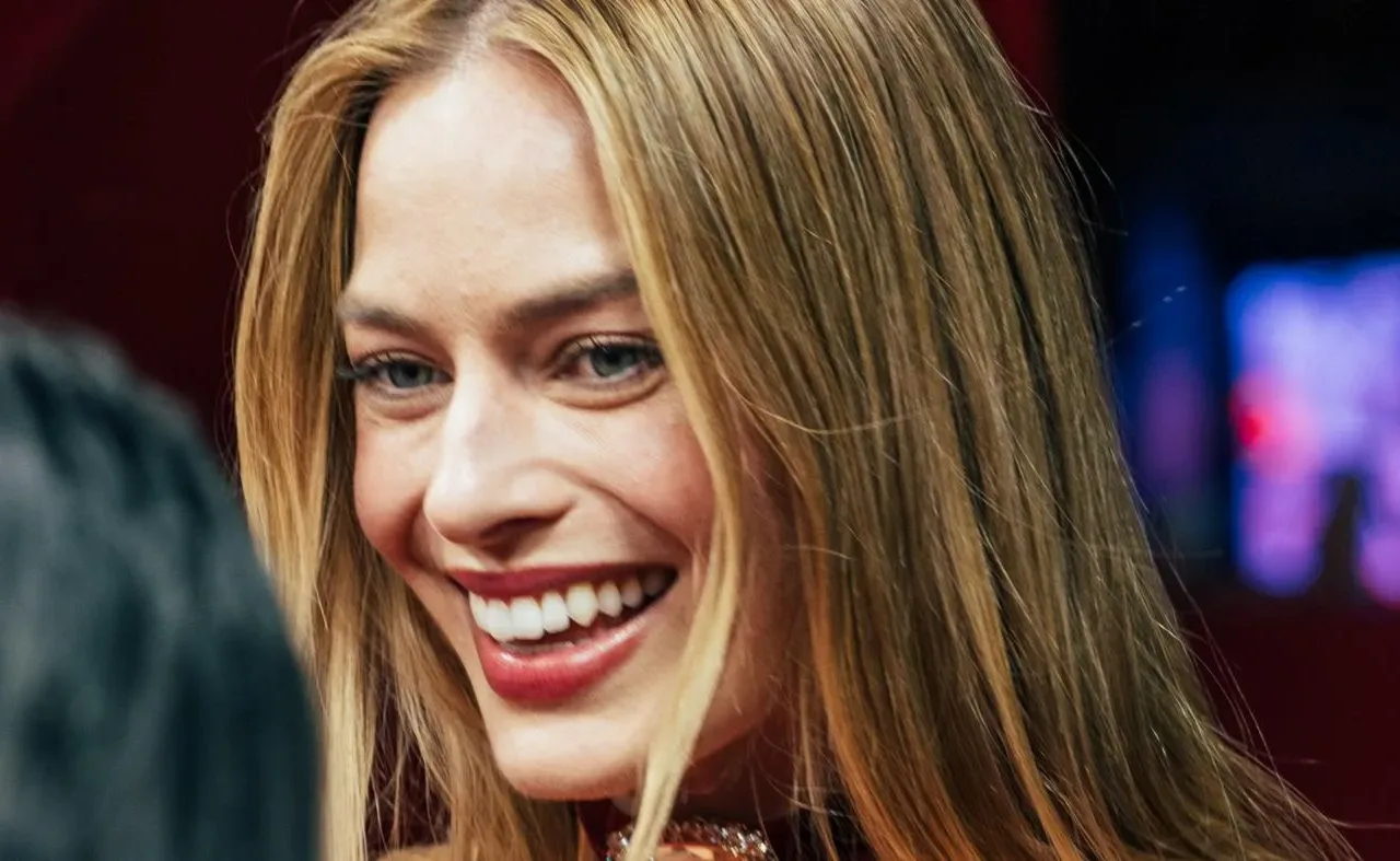 Margot Robbie smiles at the Paris premiere of Wuthering Heights in February 2026.
