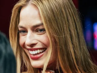 Margot Robbie smiles at the Paris premiere of Wuthering Heights in February 2026.