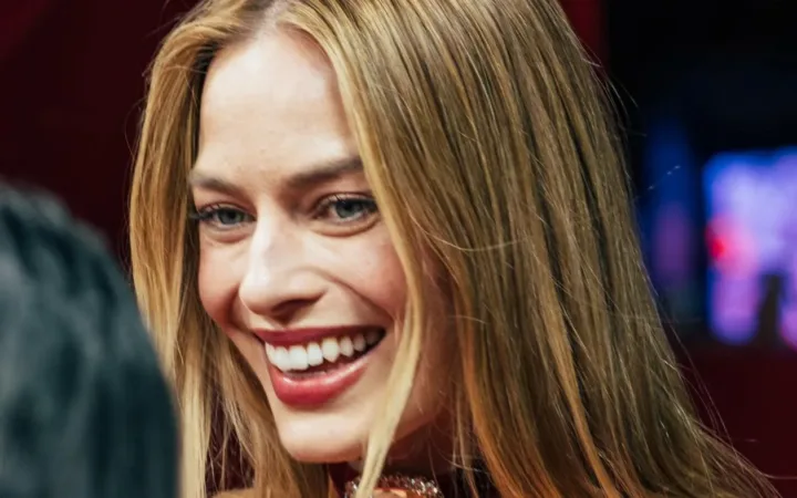 Margot Robbie smiles at the Paris premiere of Wuthering Heights in February 2026.