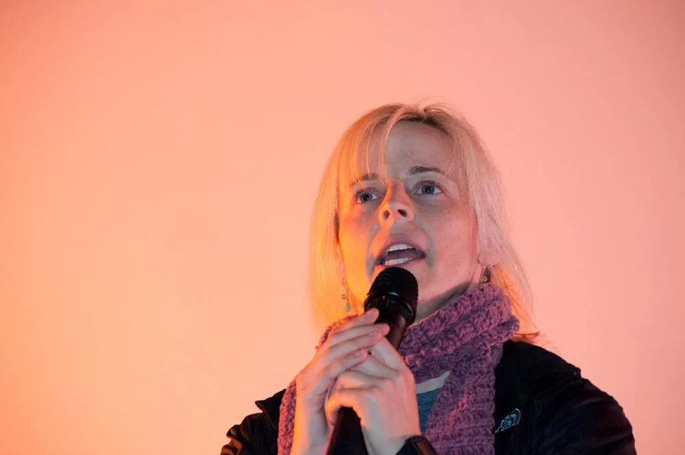 Maria Bamford holding a microphone during an archive performance in March 2011