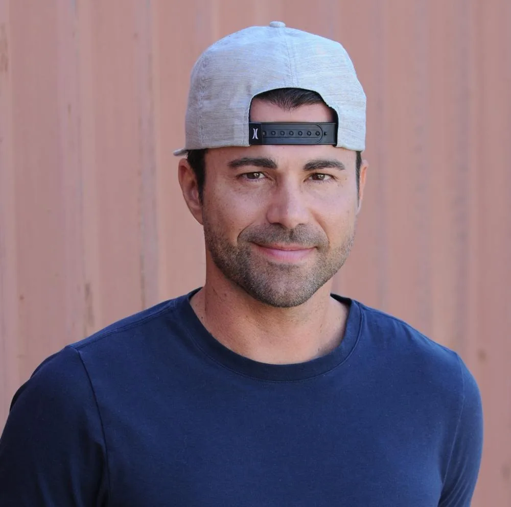 Mark Rober in a September 2024 portrait wearing a blue shirt and cap