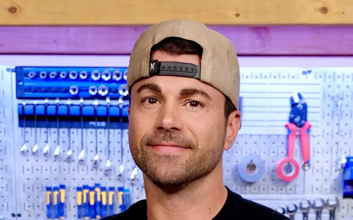 Mark Rober wearing a backwards cap in front of workshop tools, January 2025