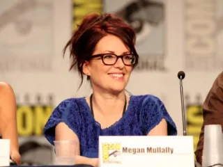 Megan Mullally smiling at a Comic-Con panel in San Diego in July 2011