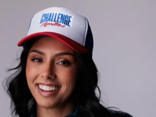 Michelle Khare wearing a Challenge Accepted cap and a blue jacket