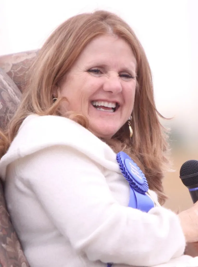 Nancy Cartwright smiling with a microphone at the 2011 Phoenix Veterans Day parade