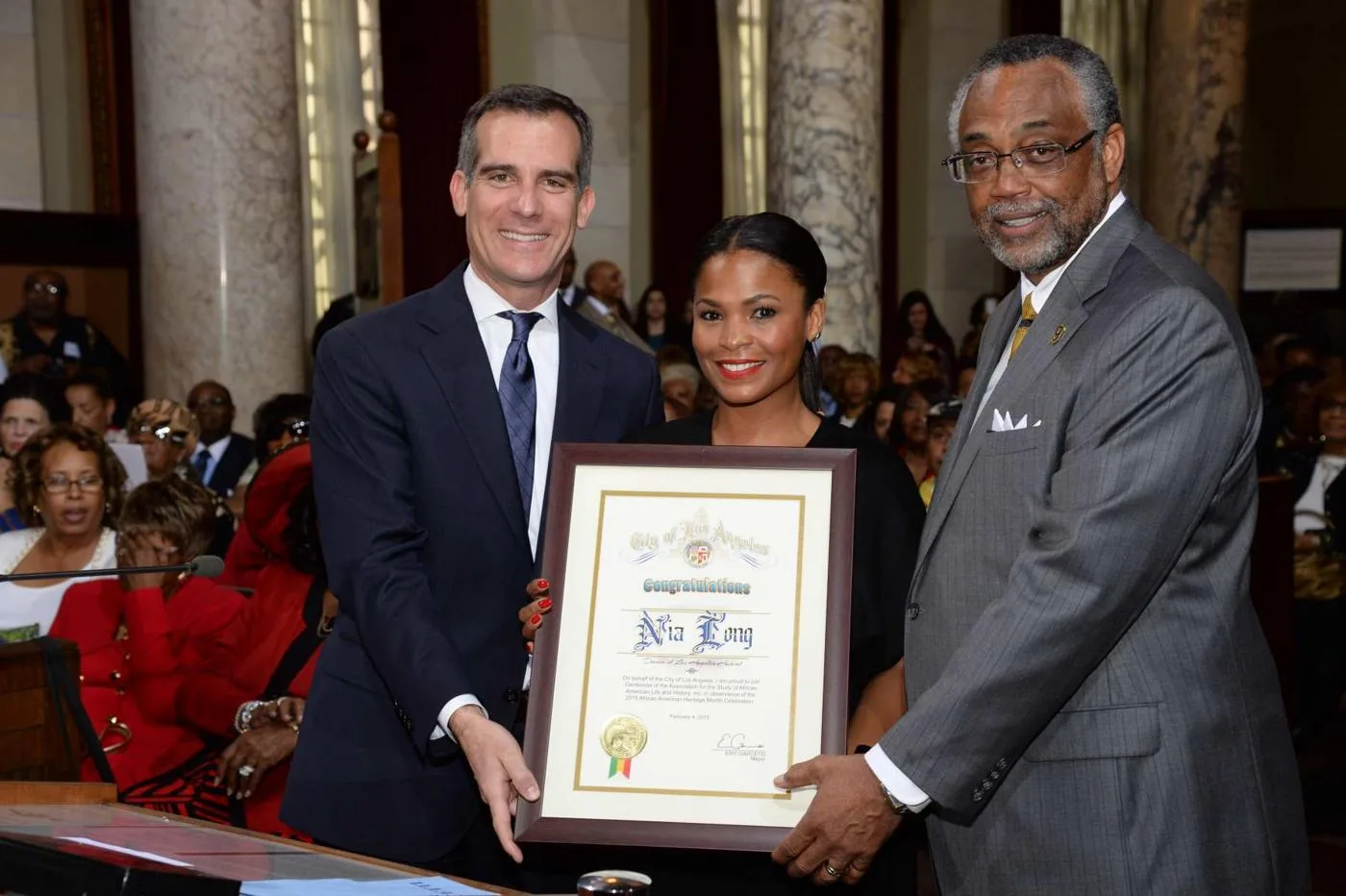 Open the featured image for Nia Long at 56: Michael, a Memoir and Her Next Chapter Nia Long, centre, holding the Dream of Los Angeles Award with Eric Garcetti and Curren Price in 2015