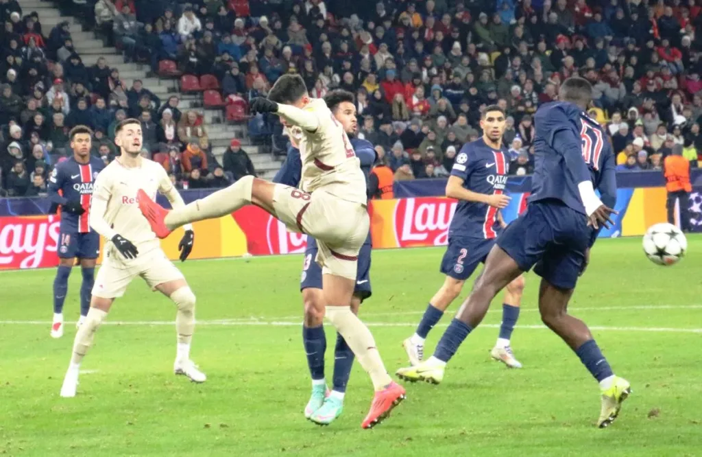 Players contest the ball during Salzburg against Paris Saint-Germain in December 2024