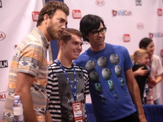 Rhett McLaughlin at left and Link Neal at right posing with an attendee at VidCon 2014