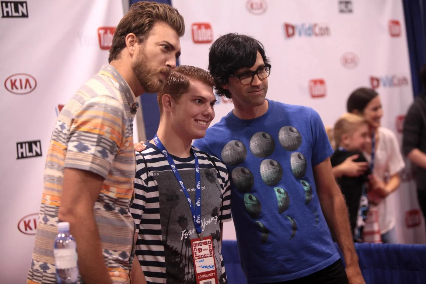 Rhett McLaughlin at left and Link Neal at right posing with an attendee at VidCon 2014