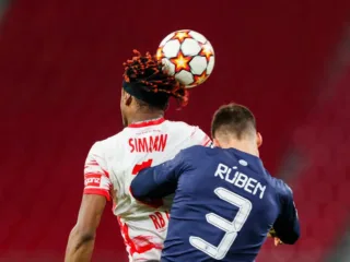 Rúben Dias, right, challenges Mohamed Simakan for a header in a December 2021 match