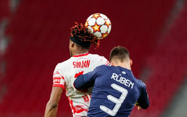 Rúben Dias, right, challenges Mohamed Simakan for a header in a December 2021 match