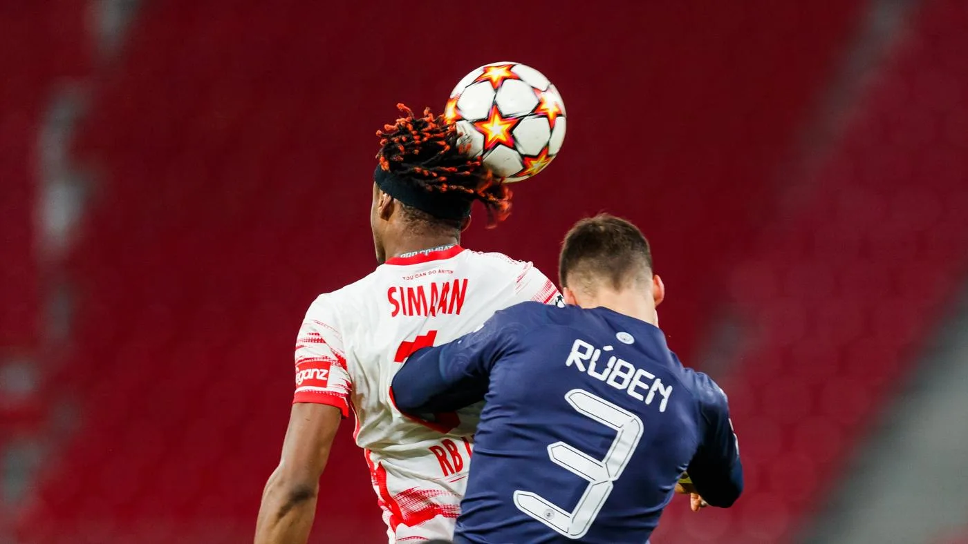 Rúben Dias, right, challenges Mohamed Simakan for a header in a December 2021 match