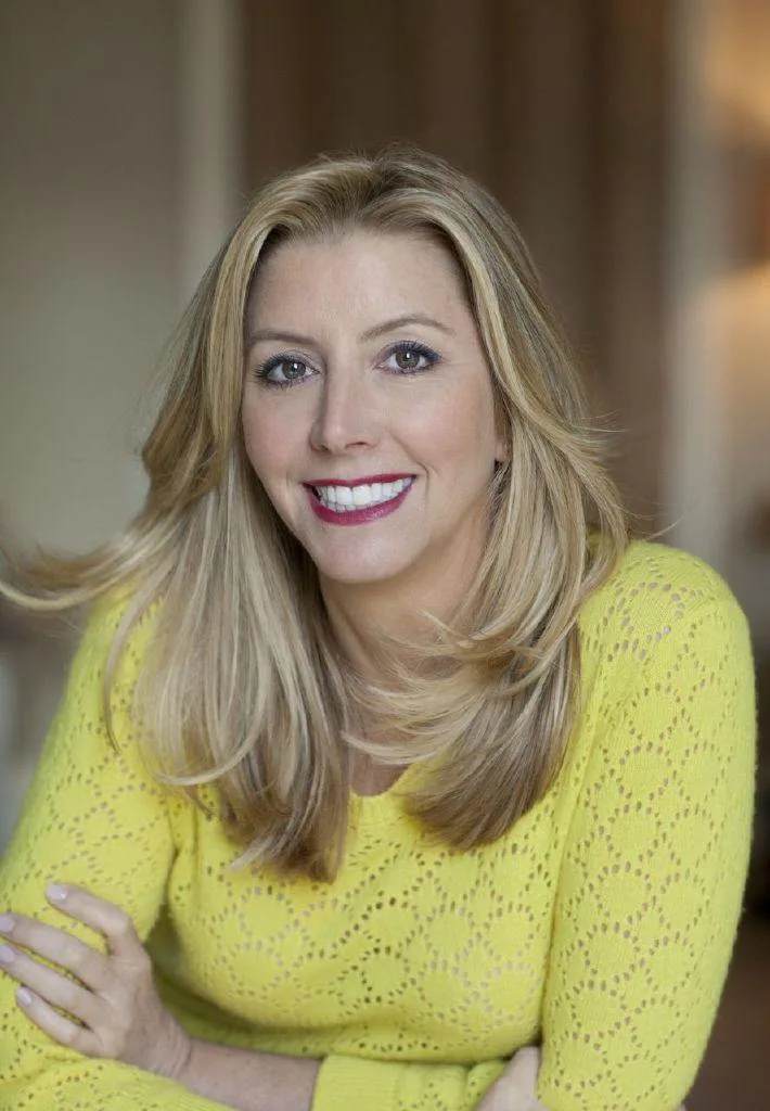 Sara Blakely in a yellow top in a portrait taken in 2014