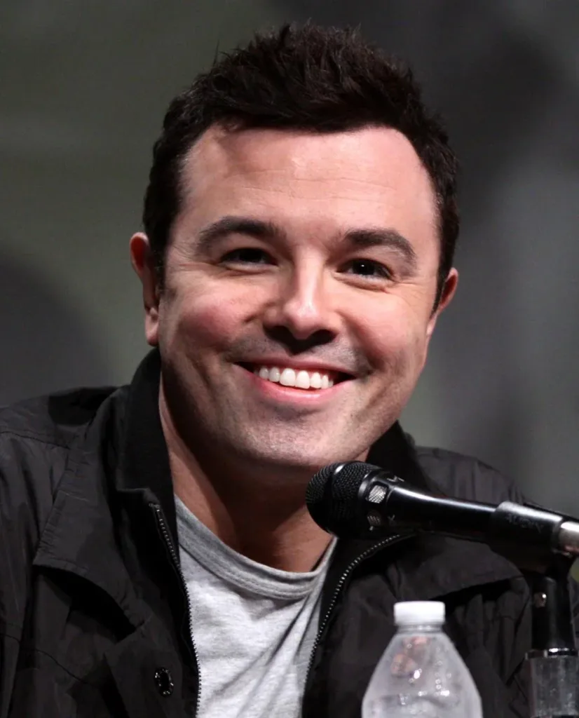 Seth MacFarlane smiles at a microphone during San Diego Comic-Con in 2012.