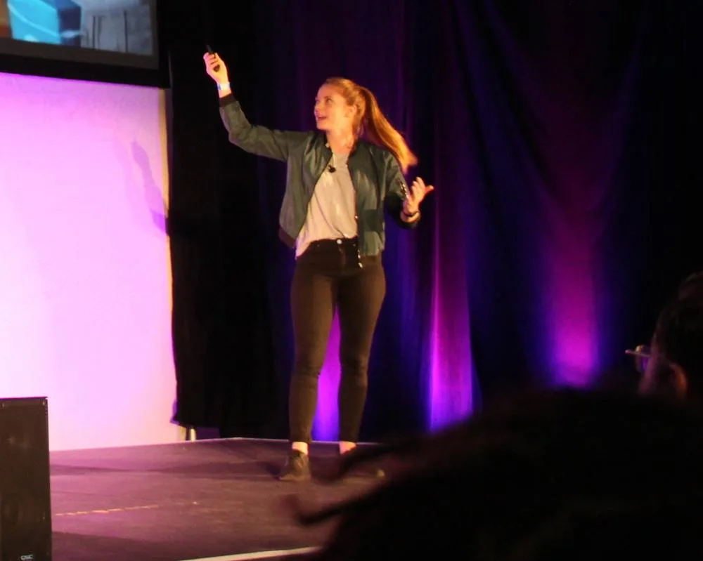 Simone Giertz speaking and gesturing on a stage in San Francisco in 2016
