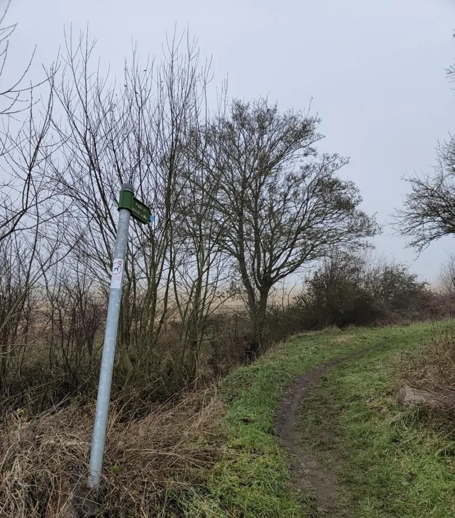 A public bridleway sign beside a grassy route at Old Warden, England.