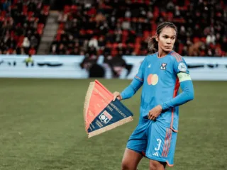 Wendie Renard holding the Lyon pennant before a 2023 match in Prague