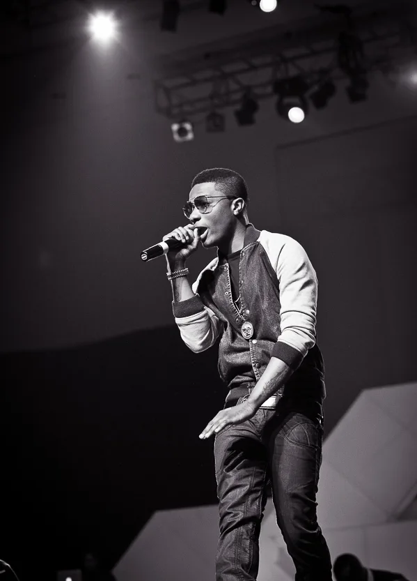 Wizkid singing at Iyanya's album launch concert in 2013