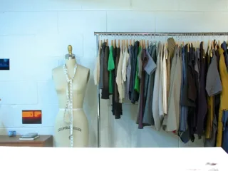 Clothes arranged on a rail with wooden hangers