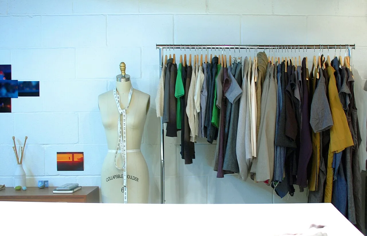 Open the featured image for Weekend Wardrobe Reset: Make Better Use of the Clothes You Own Clothes arranged on a rail with wooden hangers