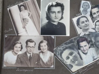An open historical family photograph album with handwritten captions