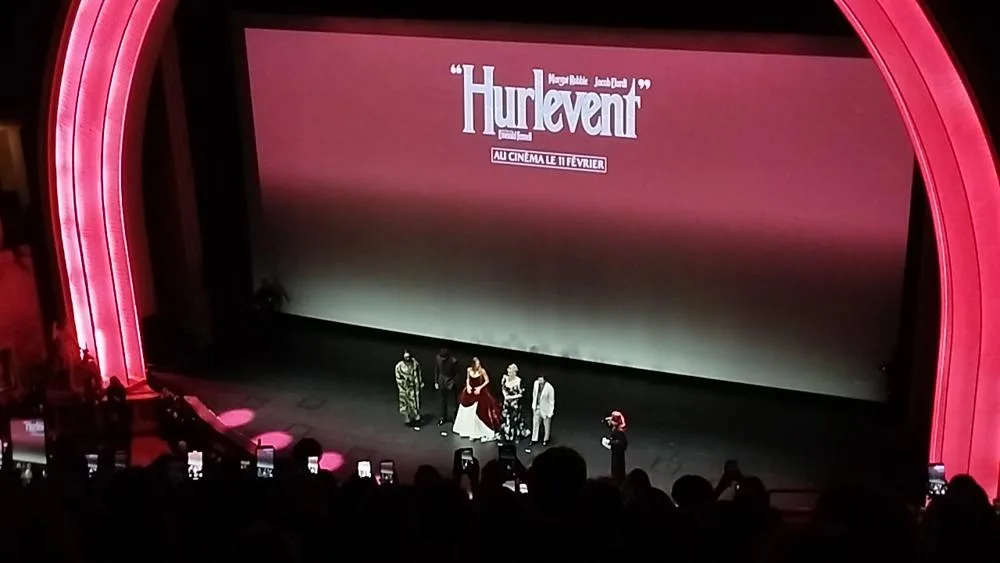 The Wuthering Heights filmmakers and cast stand on stage beneath the French title Hurlevent at Le Grand Rex.